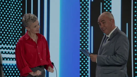 Host talking to contestants during recording of a fictional morning game show Stock Footage 246591122