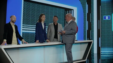 Host talking to contestants during recording of a fictional morning game show Stock Footage 246591300