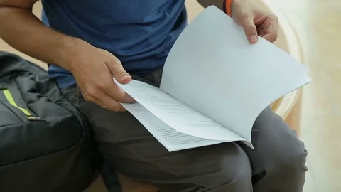 Host of tv program reading script before shooting, student preparing for exam Video stock 77276197