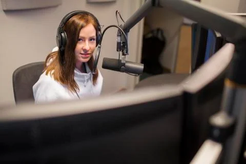 Host Wearing Headphones While Using Microphone In Radio Studio Stock Photos