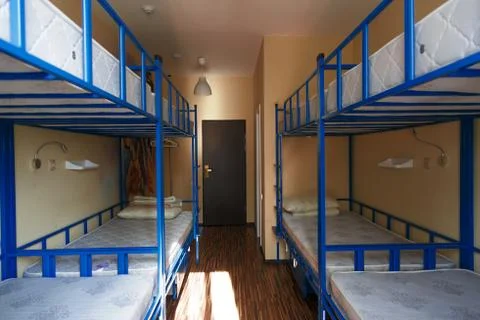 Hostel dormitory beds arranged in dorm room Photos