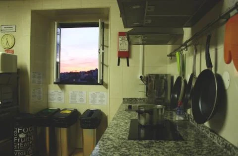 Hostel kitchen with view on Lisbon sunset Stock Photos