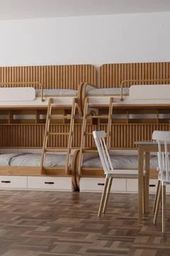 This hostel room features two sets of bunk beds along one wall and a small .. Stock Illustration