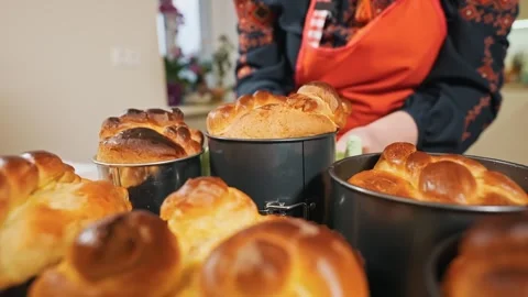 The hostess, the baker in the kitchen puts ready-made Easter bread on the table Stock Footage 254028381