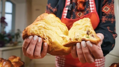The hostess, the baker tears the Easter bread that is fresh out of the oven in Stock Footage 254028410