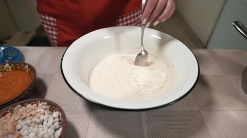 The hostess in the kitchen prepares the dough mixture Stock Footage 253486657