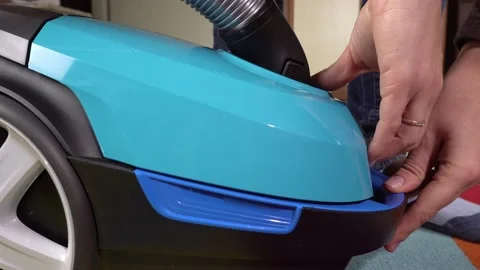 The hostess opens the compartment of the vacuum cleaner and takes out the bag Stock-Footage 150184388