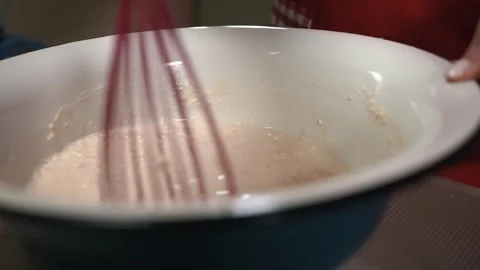 The hostess is preparing dough in the kitchen. Mix to a thick consistency. Close Stock Footage 253486653