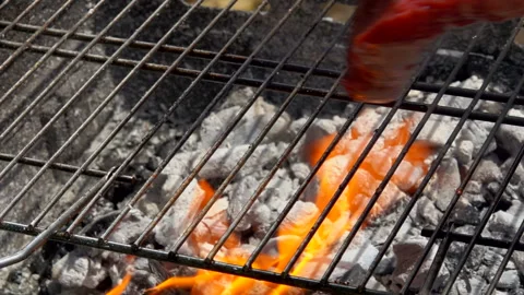 Hostess puts steak using tongs on the grill grate Video stock 104509021