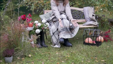 The hostess sits on a bench and calls her dog Stock Footage 161786066