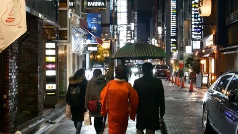 A Hostess Walking with Her Patron in the Rain in Ginza Stock Footage 119936074