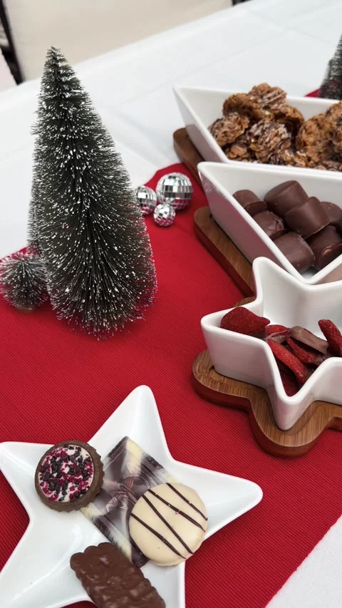 Hosting Christmas table display with chocolates and decor, red and white Stock Footage 327304892