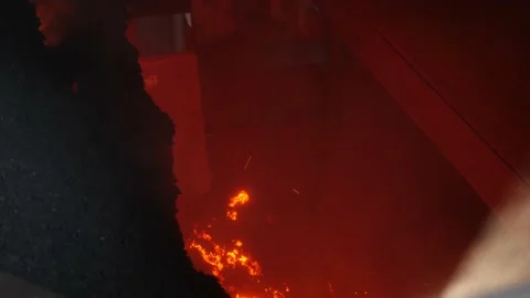 Hot agglomerate falls onto crushers. Stock Footage 139692973