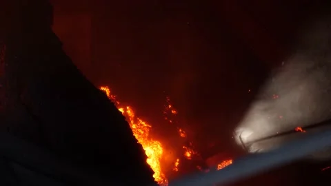 Hot agglomerate falls onto crushers. Stock Footage 139692979