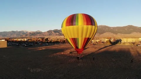 Hot air ballon preparing for launch in bozeman montana drone shot sky sunset Stock Footage 156215238