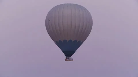 A hot air balloon flies against a purple sky. Stock Footage