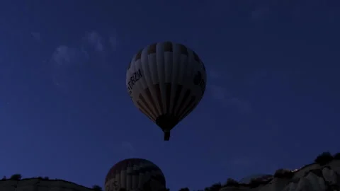 Hot Air Balloon Floating at Dusk Over Cappadocia Stock Footage 282929295