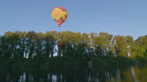 Hot air balloon floating over river Stock Footage 59793887