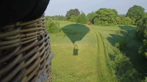 Hot air balloon flying over forest Stock Footage