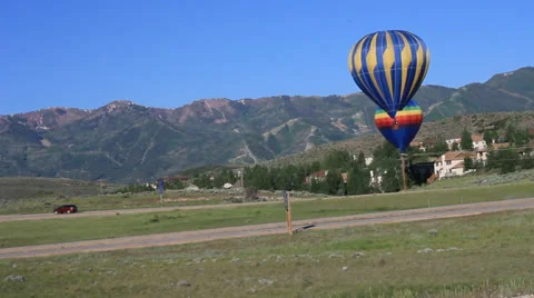 Hot air balloon by the freeway Stock Footage 24773266