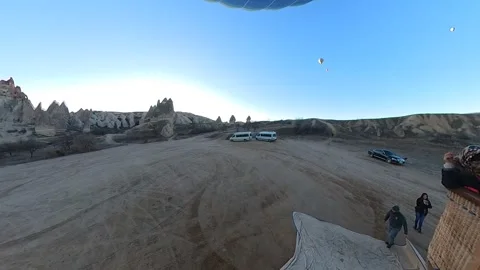 A hot air balloon glides through cappadocia with joyous passengers. Video stock 264867249