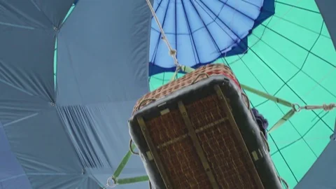 Hot air balloon goes down and basket flies over camera, burner directing flame Stock-Footage 83868385