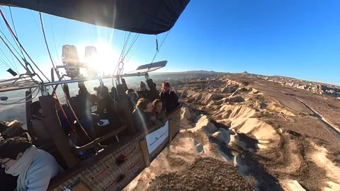 A hot air balloon gracefully soars, offering breathtaking views of Cappadocia. Video stock 265439949