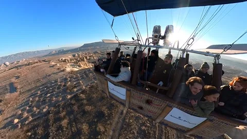A hot air balloon gracefully soars, offering breathtaking views of Cappadocia. Video stock 265440072
