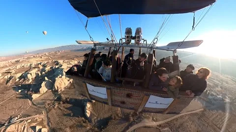 A hot air balloon gracefully soars, offering breathtaking views of Cappadocia. Video stock 265440202