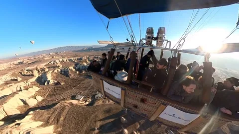 A hot air balloon gracefully soars, offering breathtaking views of Cappadocia. Video stock 265440204
