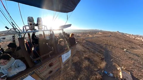 A hot air balloon gracefully soars, offering breathtaking views of Cappadocia. Video stock 265440431