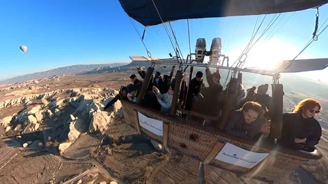 A hot air balloon gracefully soars, offering breathtaking views of Cappadocia. Video stock 265440432