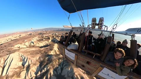 A hot air balloon gracefully soars, offering breathtaking views of Cappadocia. Video stock 265440470