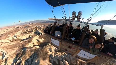 A hot air balloon gracefully soars, offering breathtaking views of Cappadocia. Video stock 265440490