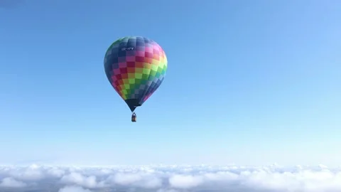 Hot air balloon hovering above the clouds Stock Footage 154274111