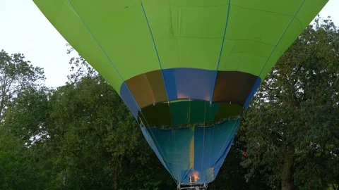 Hot air balloon inflating envelope with fire. Slow motion, close up shot Stock Footage 114319595