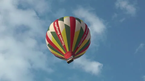 Hot air balloon with passengers, rising, seen from below Stock Footage