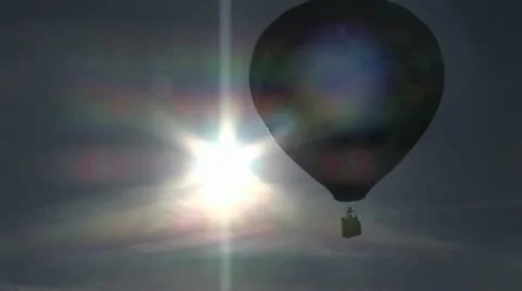 Hot Air Balloon Passing In Front of the Mid-Day Sun 스톡 동영상 19144650