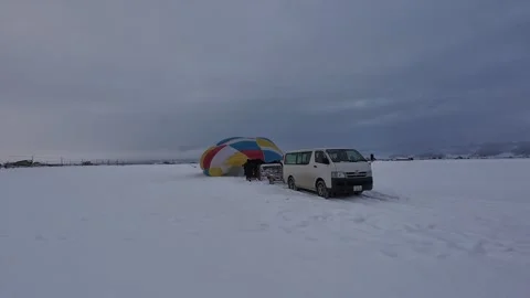 Hot Air Balloon Preparation on Snow Field in Furano Japan Видео 334454591