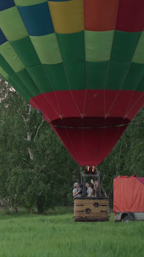 Hot air balloon prepares to launch with people in wicker basket surrounded by Stock Footage 348252201