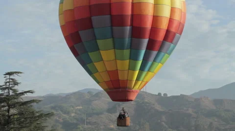 Hot air balloon sailing through a valley 動画素材 41868962