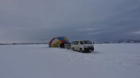 Hot Air Balloon Setup on Snow Covered Field in Furano Vídeos de archivo 334454604