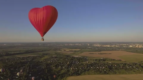 Hot air balloon in the sky over a wheat field.Aerial view Stock Footage 68343384