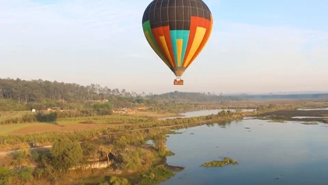 Hot air balloon, at sunrise. Flying above the lake. Hot air ballon reflection. Stock Footage