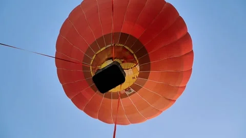 A hot air balloon taking off from a flat field Stock Footage 162698719