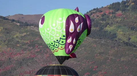 Hot air balloons with fall colored mountains in the background Stock Footage 68046743