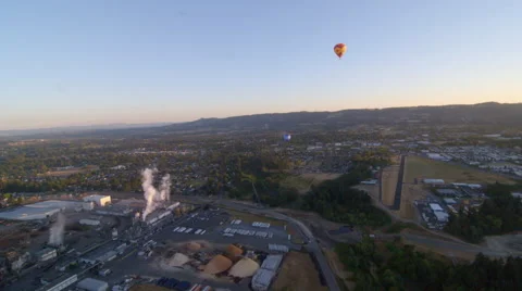 Hot air balloons float over small town Stock Footage 59171039