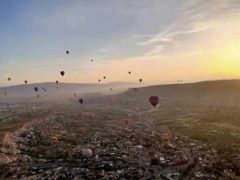 Hot Air Balloons Floating in the sky At Morning Sunrise Taken From High Altitude 库存照片