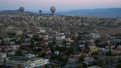 Hot air balloons flying over Goreme at sunrise. Cappadocia. Turkey Stock Footage 86204501