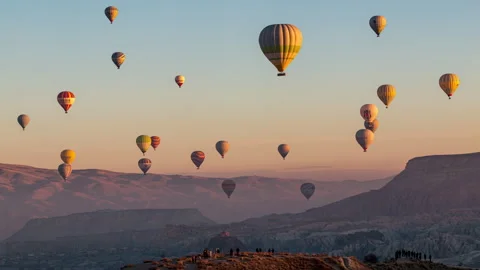 Hot air balloons flying over the valley at Cappadocia, Turkey. Video stock 201736748